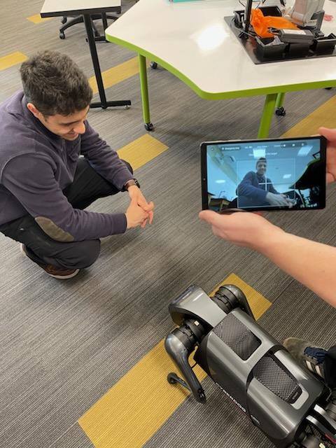 Students work with robot